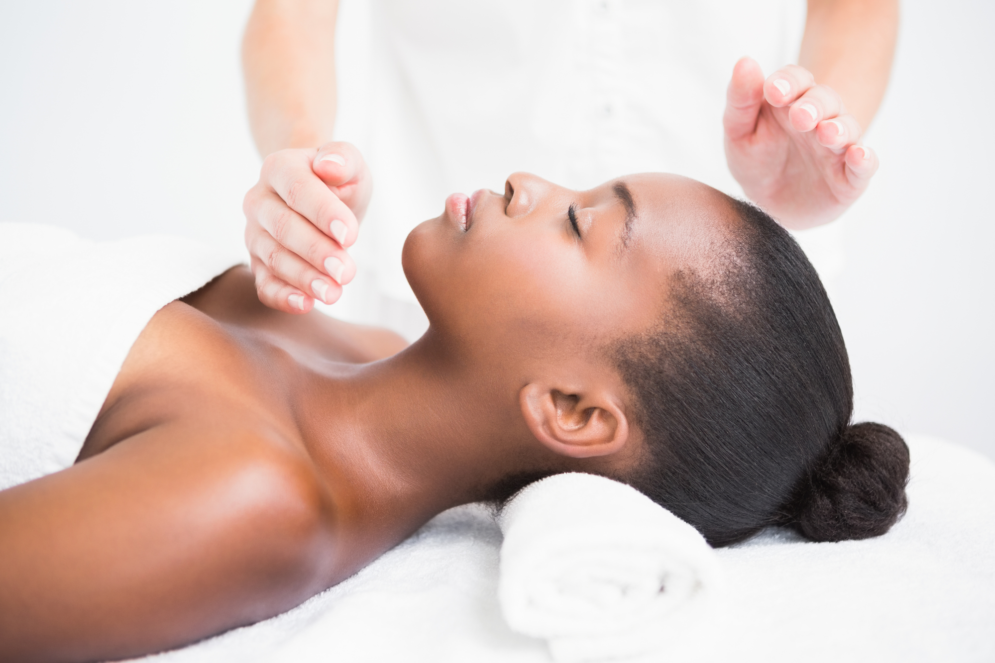 Pretty woman enjoying a reiki technique at the health spa